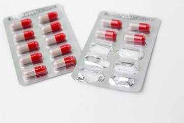 Red and white Medicine capsule on white background. Health and medical concept.