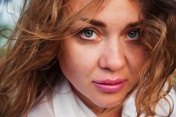 Outdoor closeup portrait of beautiful young woman. Natural light. Close-up.