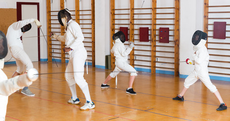 Obraz premium Young fencers training with coach