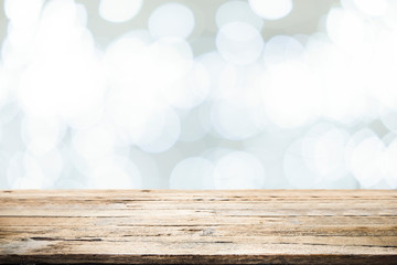 Fototapeta premium Wooden table with bokeh abstract background.