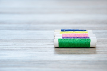 A row of rolls of thread with only one in focus