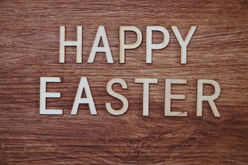 Happy Easter text message on wooden background