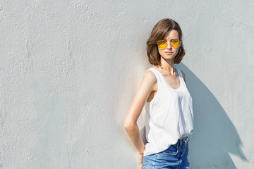 Portrait of a teenage girl in yellow glasses. Copy space.