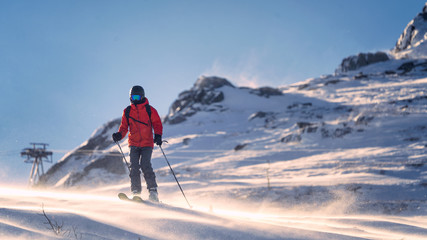 Fototapeta na wymiar Skier on the mountain in a strong wind
