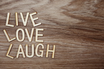 Fototapeta premium Live Love Laugh text message on wooden background