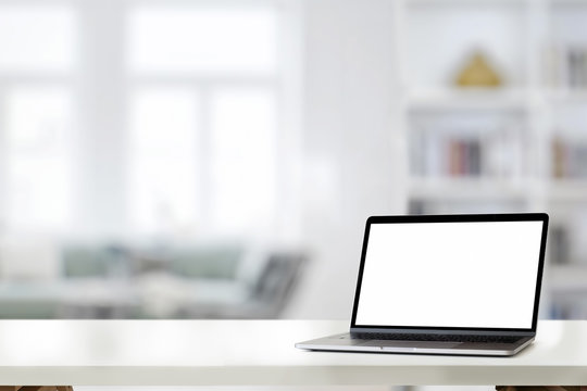 Mockup laptop on white desk at home