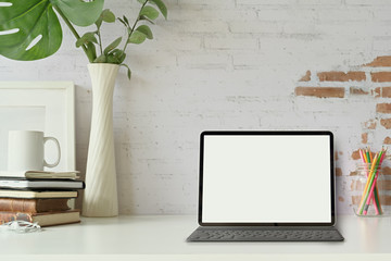 Front view of the tablet with Smart Keyboard on loft workspace table.