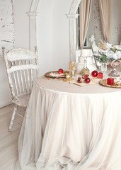Festive table with red and gold decor.