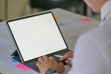 Business man working on tablet computer with blank copy space screen for your advertising graphic display