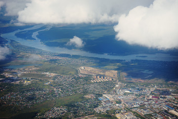 Obraz premium Landscape, the surface of the earth through the clouds from an airplane window.