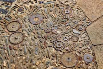 Floor with pattern from pebbles and rusty metal details