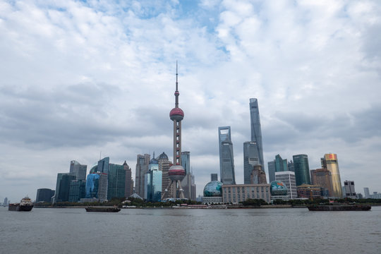 Shanghai skyline with river and cloudy sky