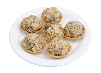 Festive handmade New Year's tartlets with mushrooms and yolk isolated