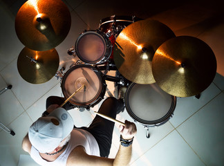 Musician plays musical percussion instrument with drumsticks