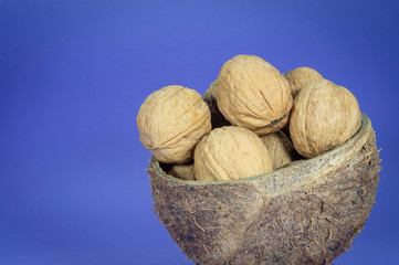 Common walnuts in natural coconut shell cup