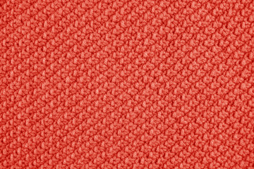 Knitted texture in Coral color. Close up.