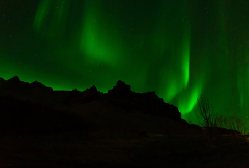 Northern lights over the landscape of Iceland