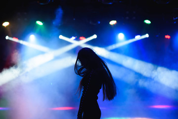 dancing silhouette of girl in a nightclub
