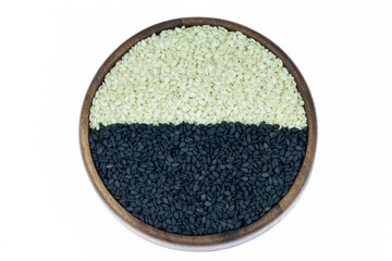 White sesame and black sesame seed on wooden coasters