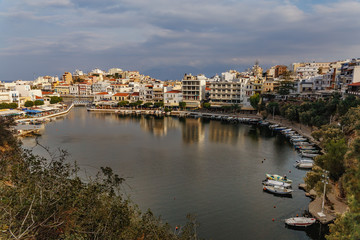 Fototapeta na wymiar top view of the bay with small white boats and the Greek city of Agios Nikolaos