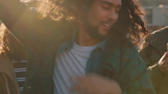 Group Of Diverse Friends Hanging Out Dancing Together Mixed Race Man Enjoying Rooftop Party Dance Music At Sunset Drinking Alcohol Having Fun On Weekend Gathering