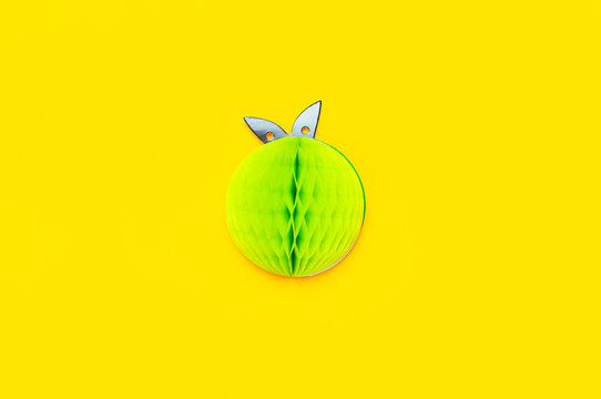 Flat lay bright sweet green apple of paper on yellow background top view copy space. Minimalistic creative summer food concept, origami paper fruit. Apple background