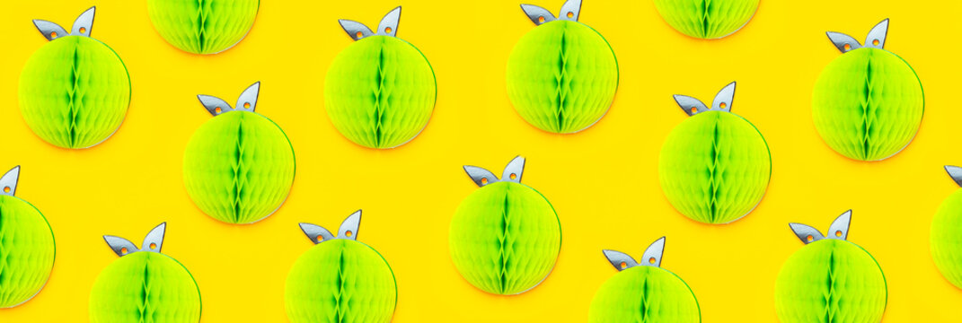 Creative summer pattern bright sweet green apple of paper on yellow background Flat lay top view copy space. Minimalistic food concept, origami paper fruit. Apple background