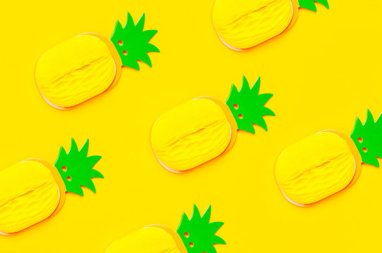 Creative summer pattern bright sweet tropical pineapple of paper on yellow background Flat lay top view copy space. Minimalistic food concept, origami paper fruit. Pineapple background