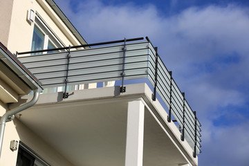 Large balcony with railing made of glass and stainless steel