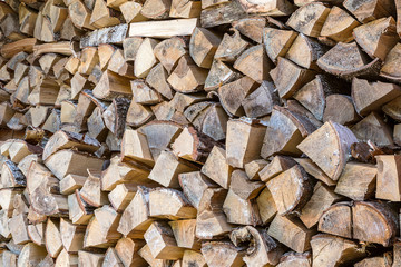 Natural wooden background. Firewood stacked and prepared for winter