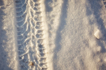 dangerous winter road riding, trail from car on snow