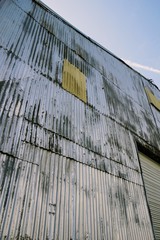 Side of a corrugated steel building.