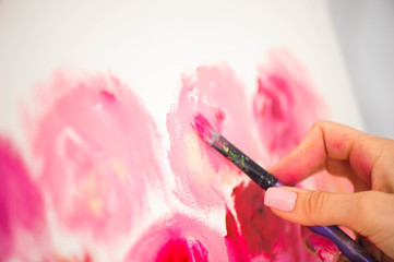 Artist close-up painting flowers.