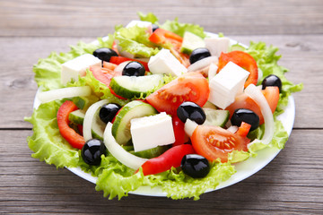Fresh greek salad on grey wooden background