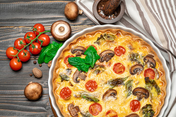 Baked homemade quiche pie in ceramic baking form