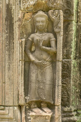 Bas-relief of standing woman in temple wall