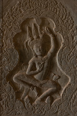 Fototapeta na wymiar Bas-relief in Angkor Wat of dancing woman