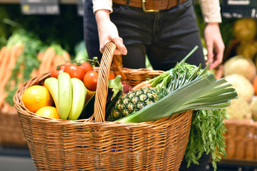 Shopping basket with fresh fruit and vegetables in the supermarket // Einkaufskorb mit frischem Obst und Gemüse im Supermarkt