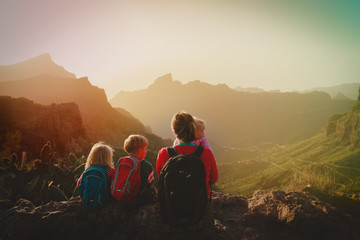 mother with three kids hiking travel in mountains