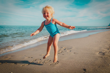 happy child play jump at sand beach