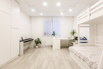 Naklejka na ściany i meble Natural, bright kid's bedroom interior with wooden furniture, designer accessories and posters on a white wall