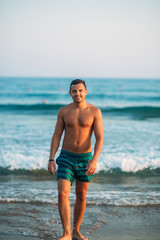 Fototapeta na wymiar Portrait of an attractive young man on a tropical beach