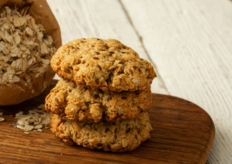 Oatmeal cookies with milk on tray on rustic wooden table