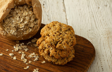 Oatmeal cookies with milk on tray on rustic wooden table