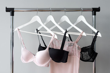 Vareity of bra hanging on a hanger. Textile, Underwear. Female bra in lingerie underwear store. Advertise, sale, fashion concept.