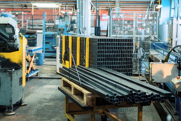 A bundle of metal rectangular profile. Industrial interior