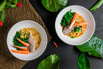 Spicy instant noodles with beef and crab sticks. top view