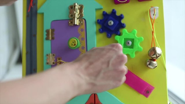 demonstration of torque parts on blackboard. Woman playing with children's educational toy