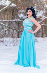 Obraz na płótnie Canvas Greece woman in blue long romantic dress at snowy day, femininity and grace concept, winter fairytale 