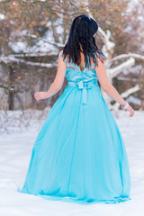 Fototapeta na wymiar Greece woman in blue long romantic dress at snowy day, femininity and grace concept, winter fairytale 
